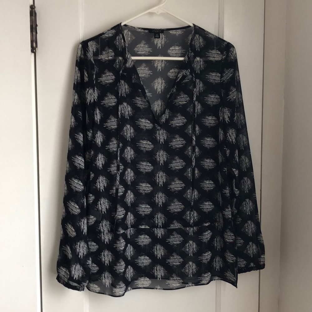 Sheer blue patterned, long-sleeved shirt.